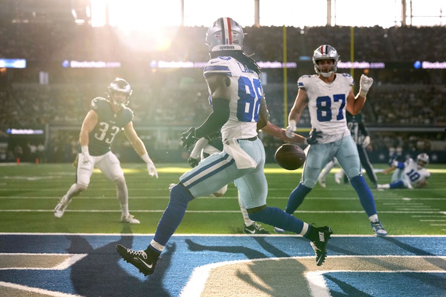 Dallas Cowboys wide receiver CeeDee Lamb runs past a pass thro