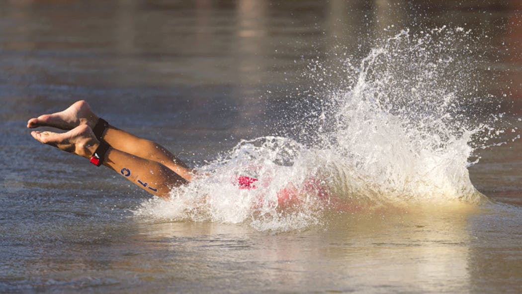 Spain's Antonio Serrat Seoane dives into the Seine.