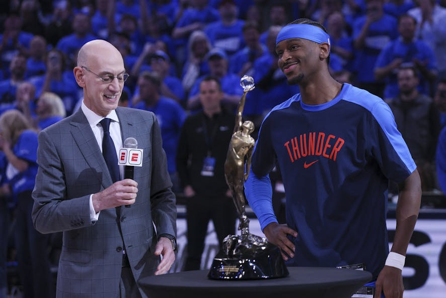Shai Gilgeous-Alexander hoists the Michael Jordan MVP Trophy